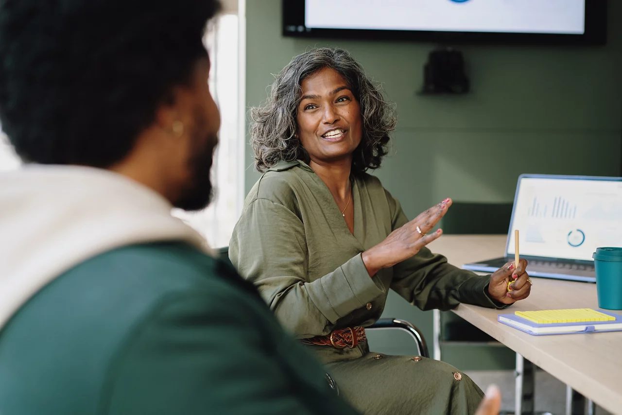 Female colleague looks back and talks to colleague