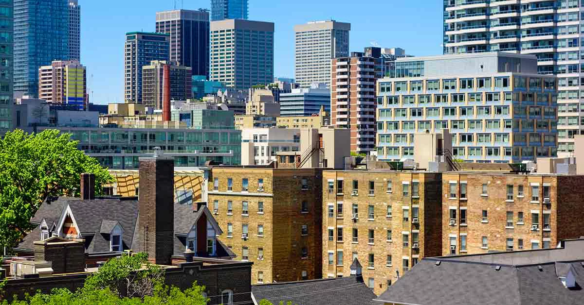 Aerial view of a metropolitan skyline captured from an elevated rooftop perspective.