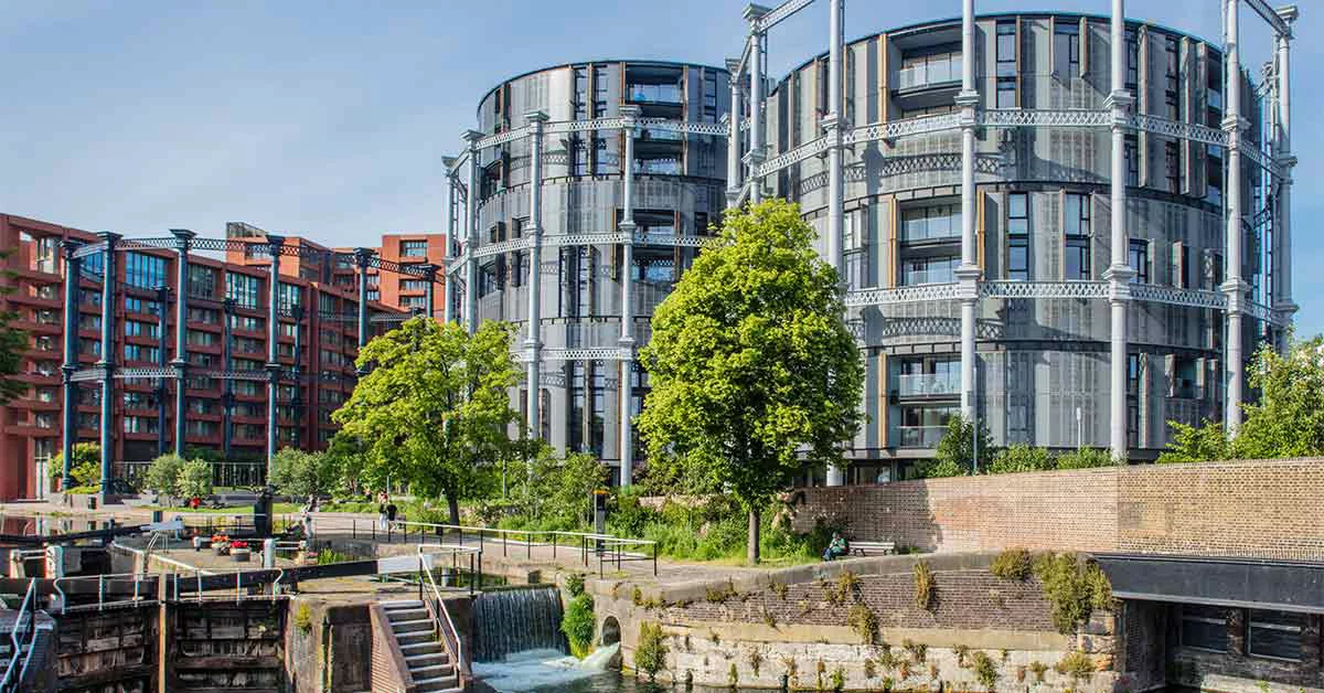 A residential development with a public park on the edge of a canal in a city