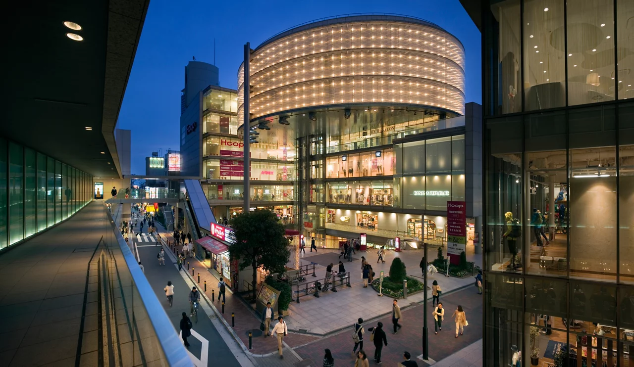 Evening image of people enjoying themselves at Abenobashi shopping district at Tennoji area of Osaka, Japan. In Front you see Hoop shopping mall.