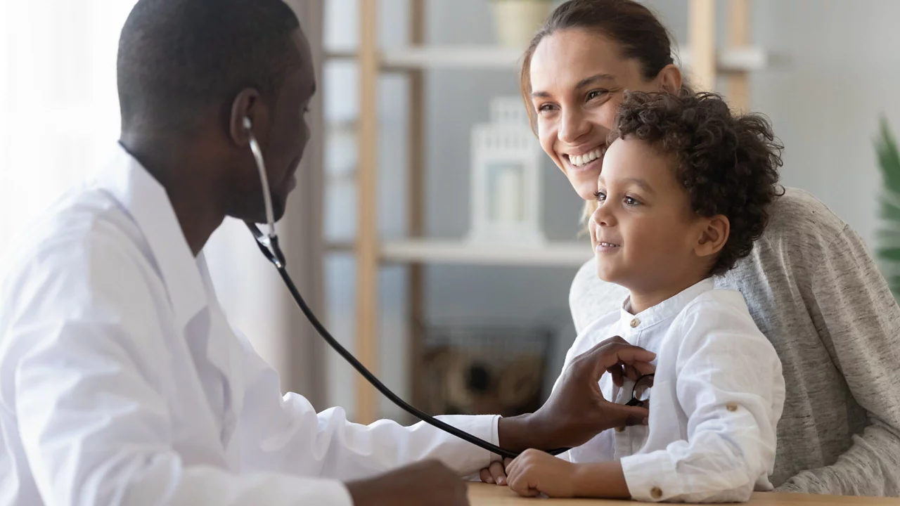 An African doctor checking a baby with a stethoscope