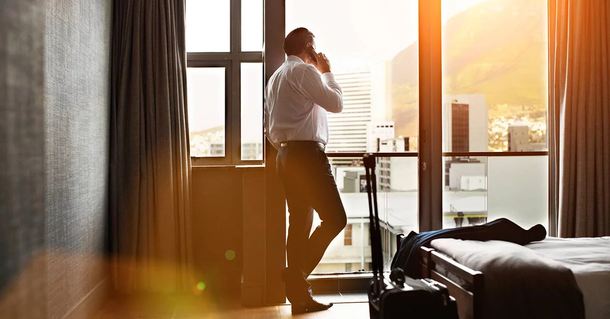 A man stands by a window