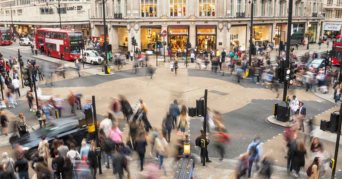 A crowded city street featuring pedestrians and vehicles