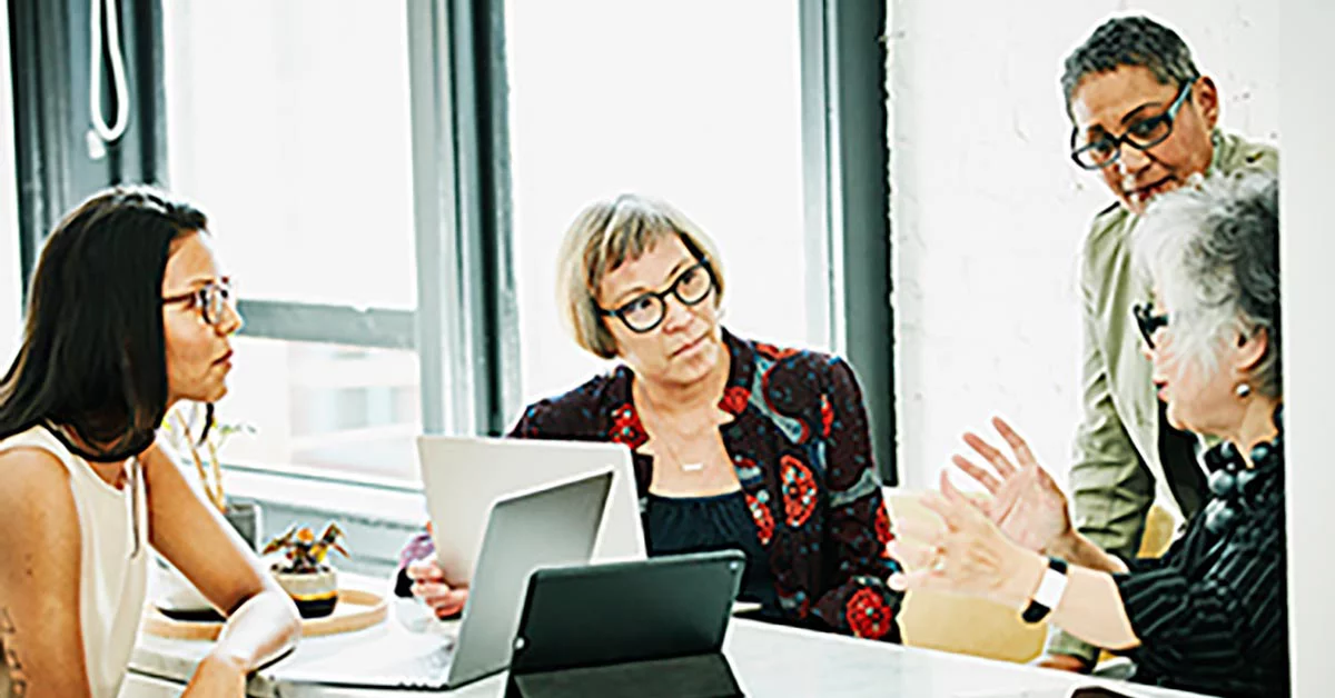 Senior business woman leading a meeting with female colleagues in an office