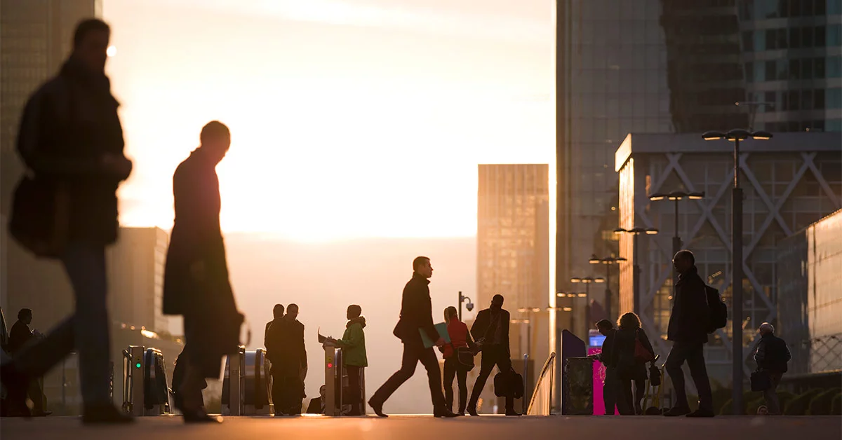 Businesswomen, businessmen and office workers walking to their offices at the business district