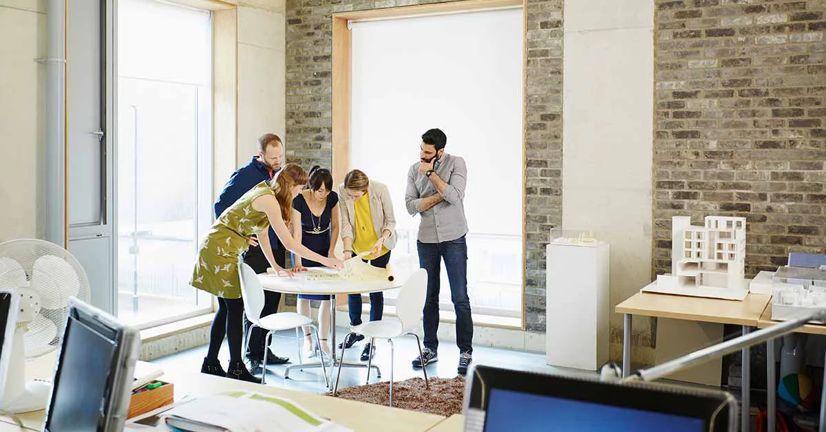 People working around a table in an office