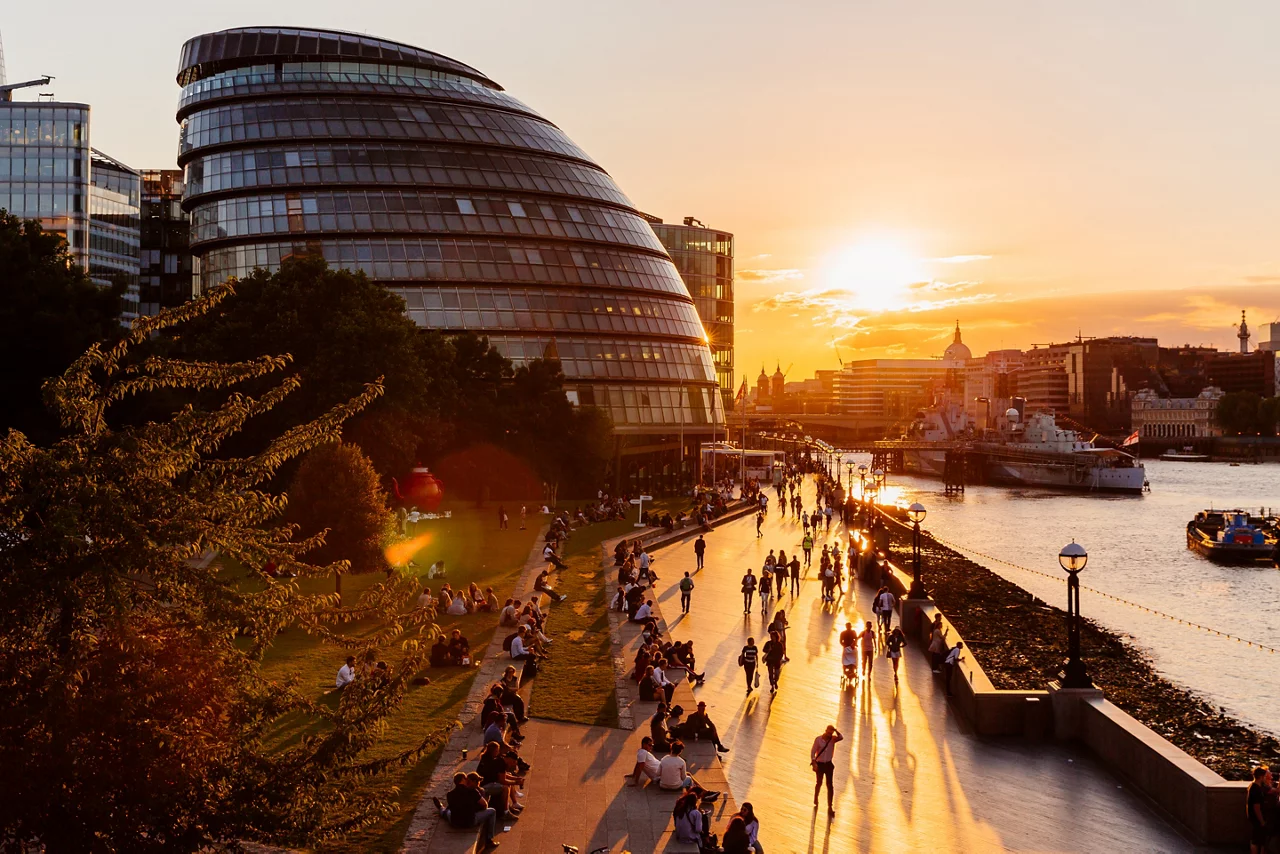 London City Hall and people walking along Thames River at sunset, London, England, UK