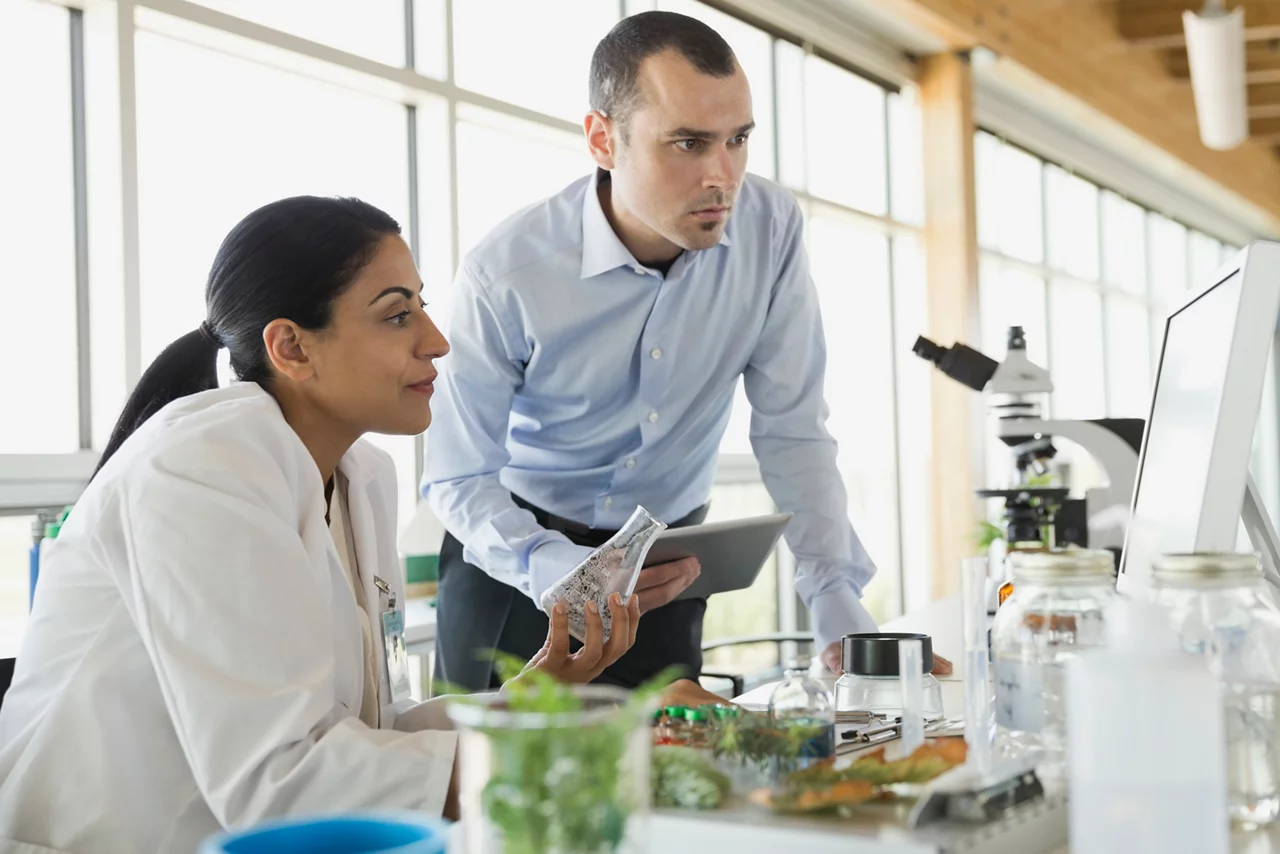 Businessman and botanist reviewing sample data