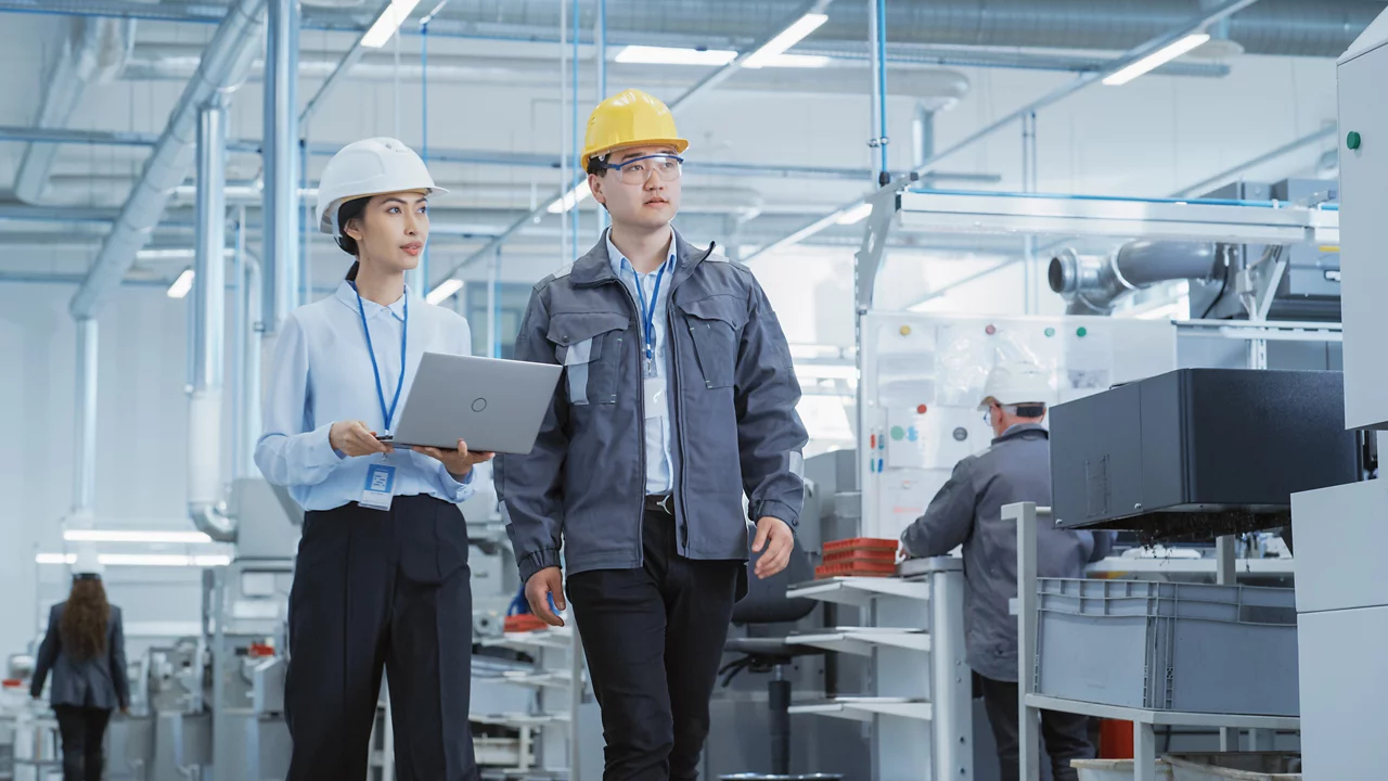 Two Professional Heavy Industry Engineers Wearing Hard Hats at Factory