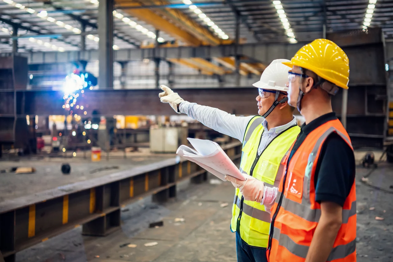 Quality inspectors working in a steel factory.