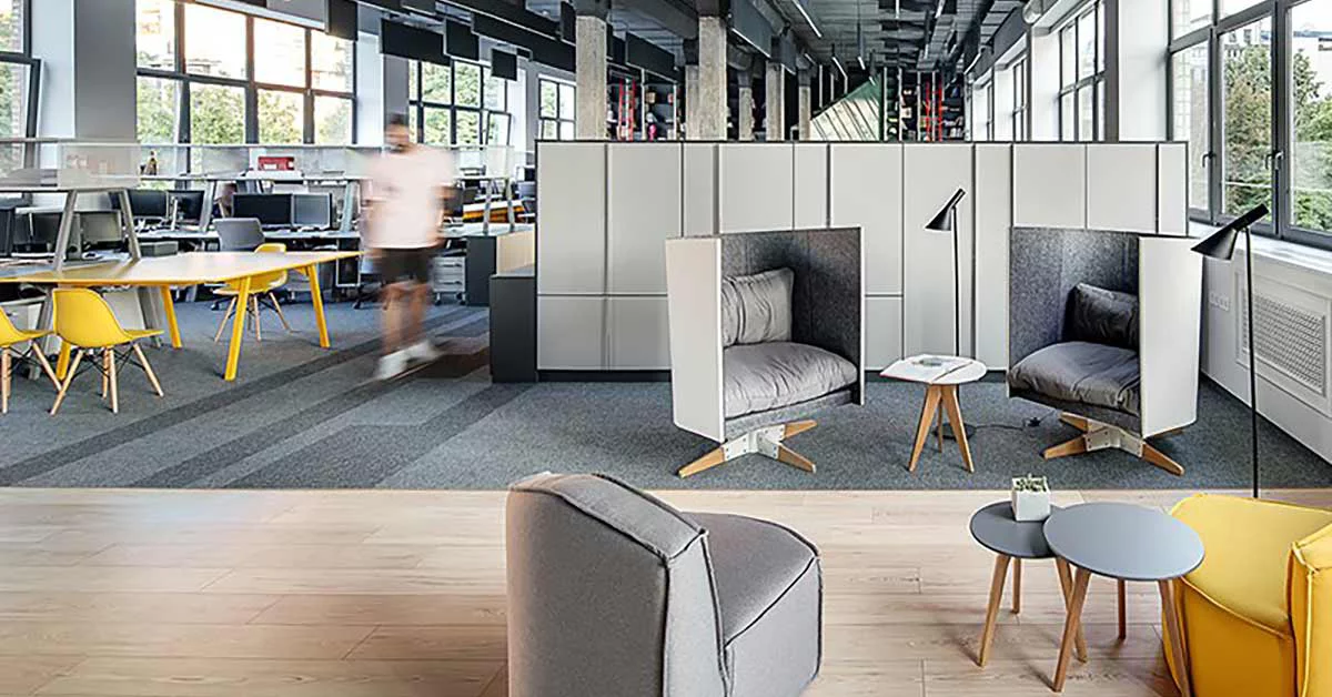 Business colleagues discussing business document sitting in office lobby