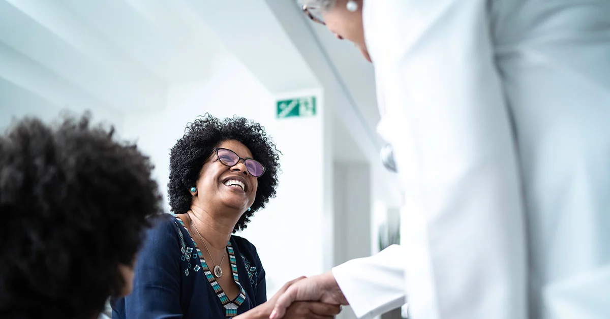 A woman smiling at the nurse