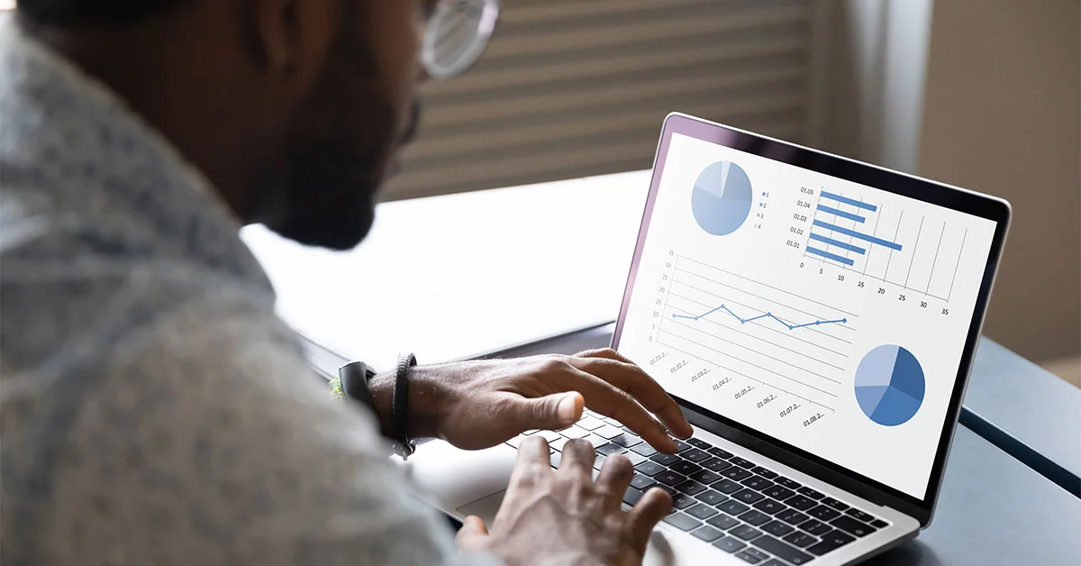 A professional observing the data on laptop