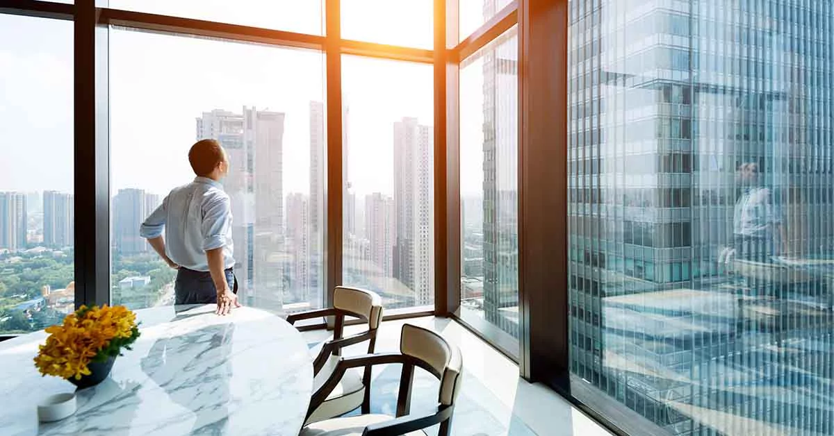 Man looking outside from office window