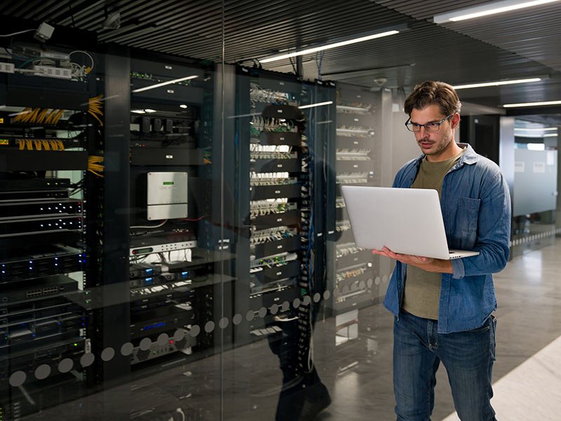 IT support technician fixing an outage on a network server