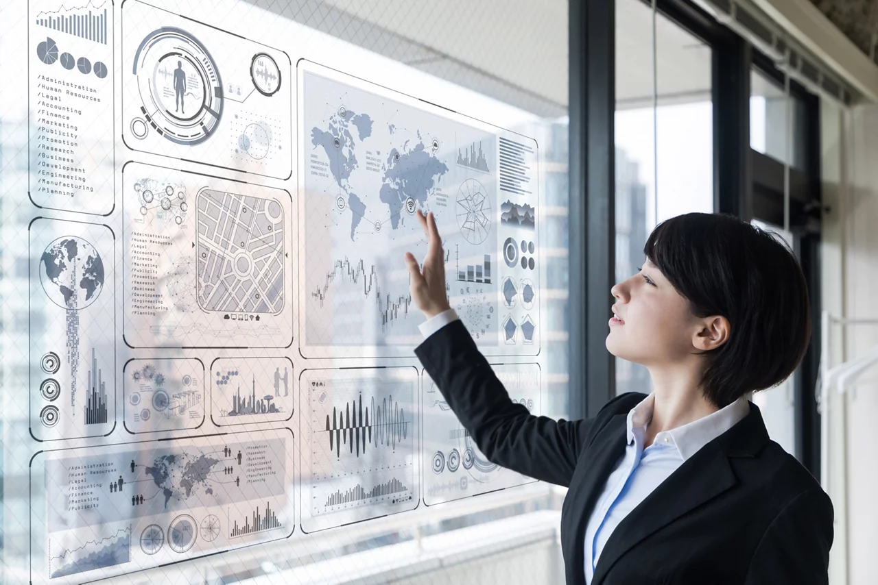 Professional woman interacts with data dashboard on smart board