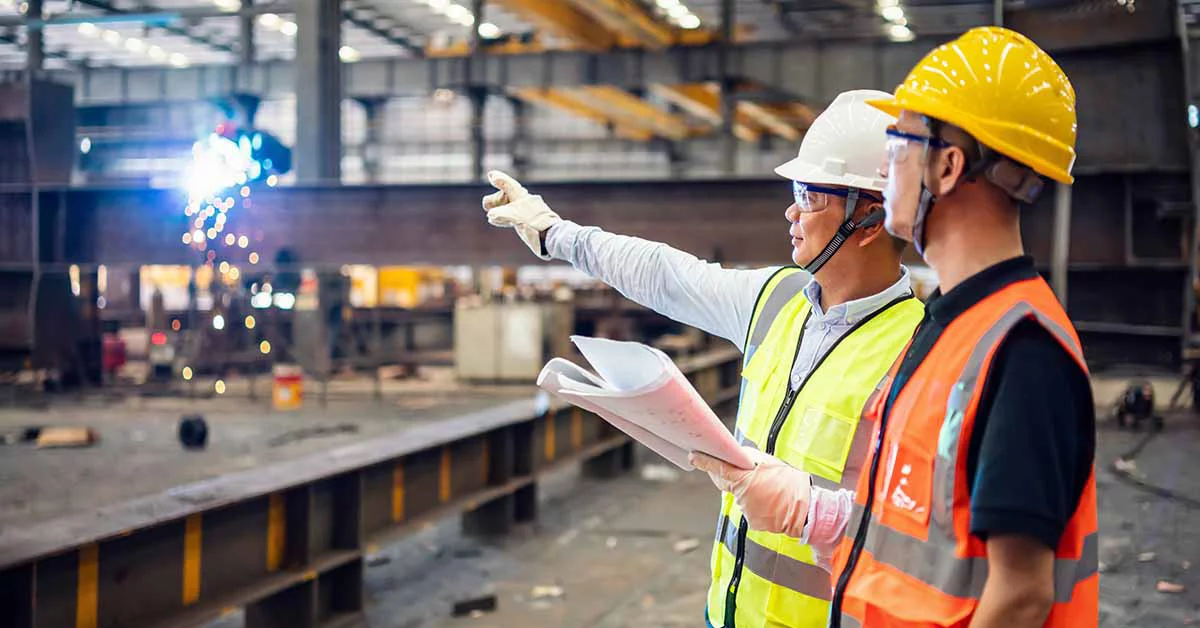 Quality inspectors working in a steel factory