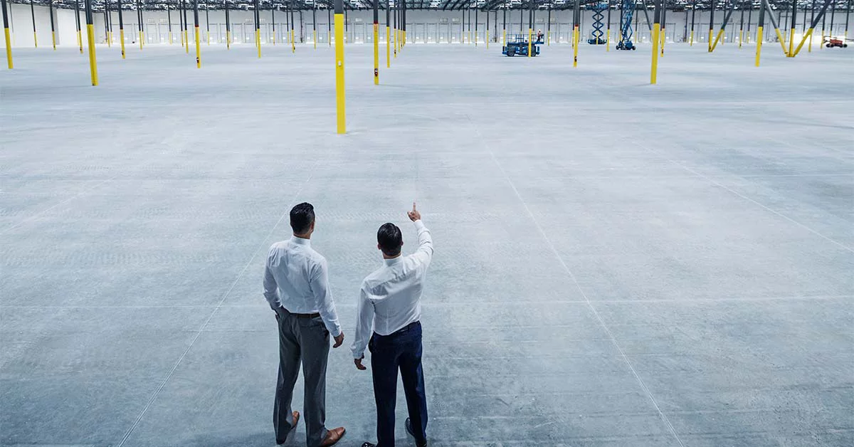 Businessmen talking in empty warehouse