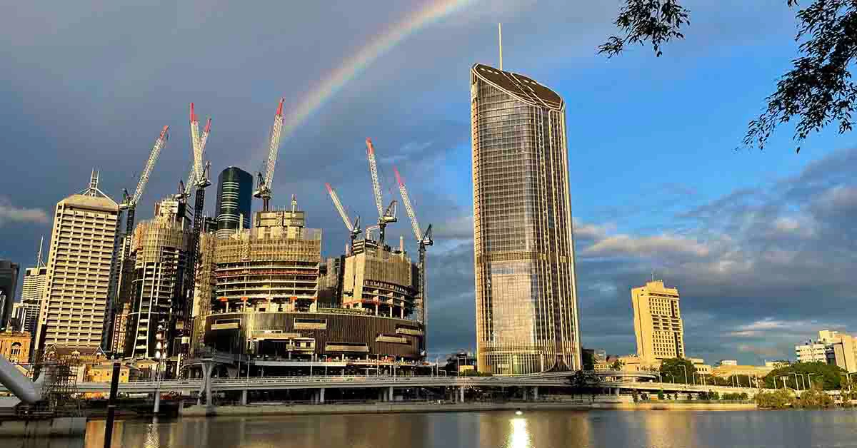 Building near to lake with rainbow behind