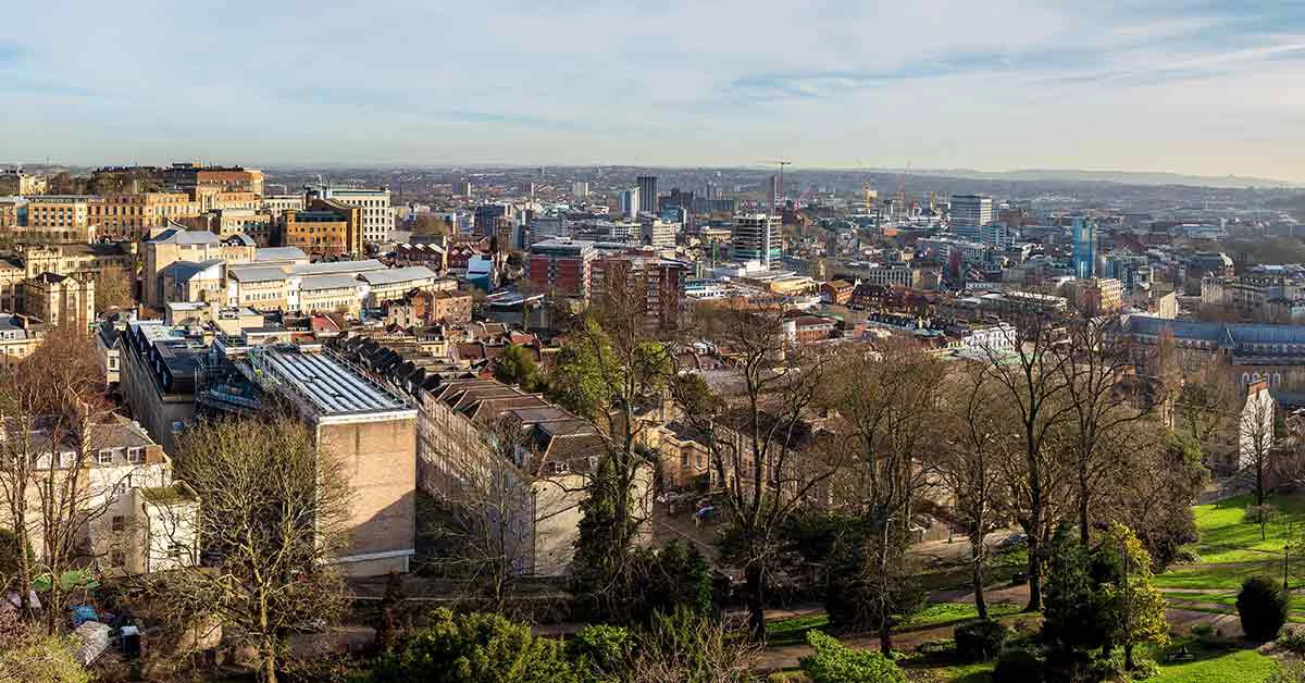 Panoramic view of Edinburgh cityscape from a hilltop.