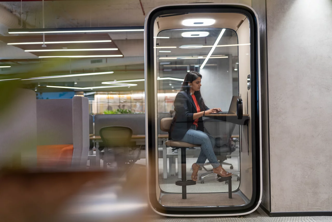 Lady working in glass cubical