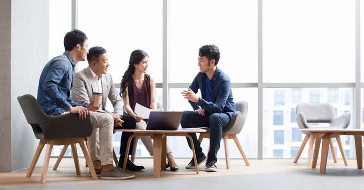 Small team gathered around for a discussion