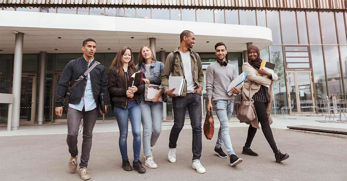 Six university students walking out of a building
