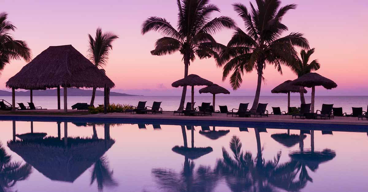 A serene poolside scene at sunset.