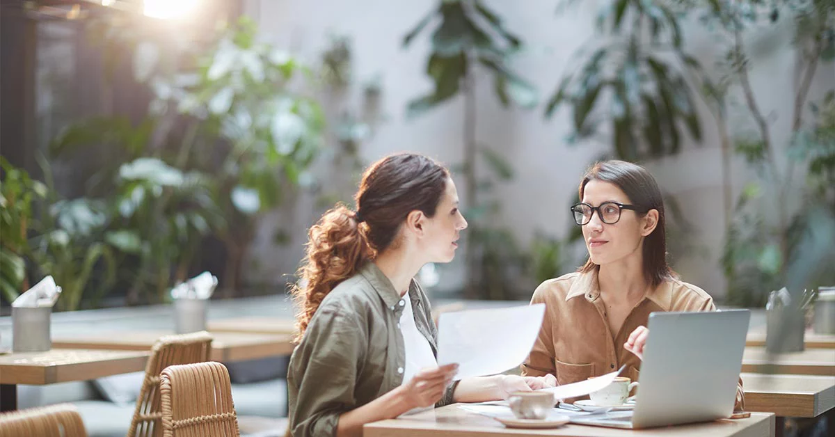 Two Young Businesswomen in Cafe