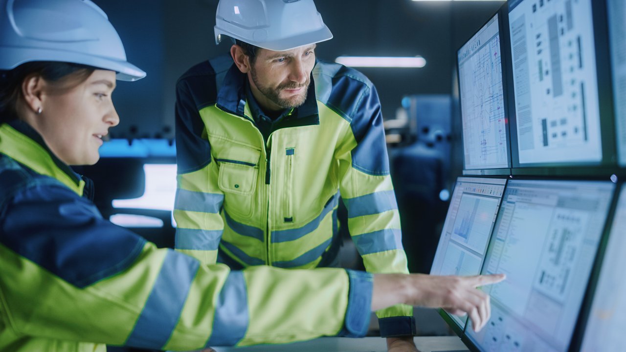 Project Engineer Talks to Female Operator who Controls Facility Production Line