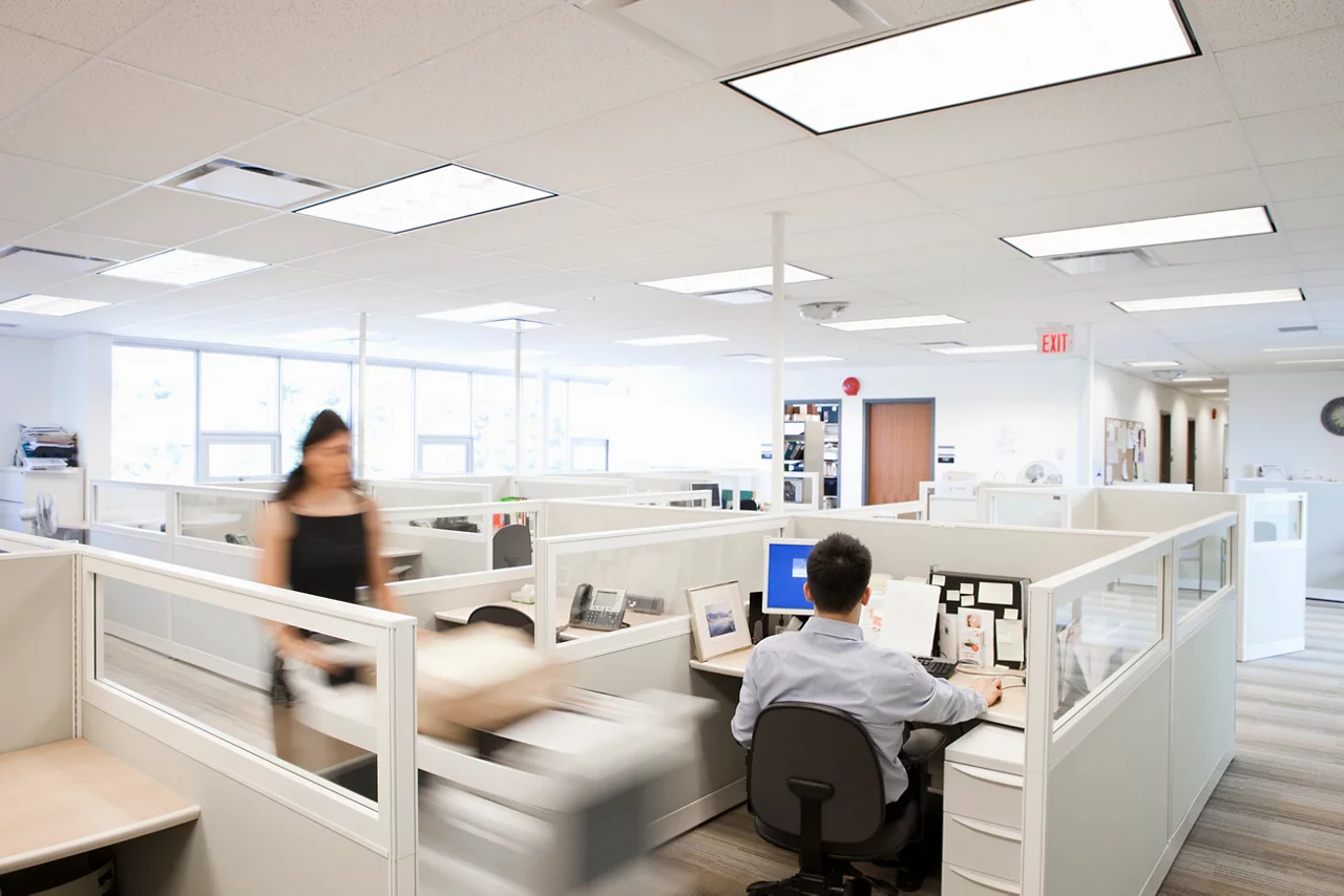 Woman pushing mail cart through office