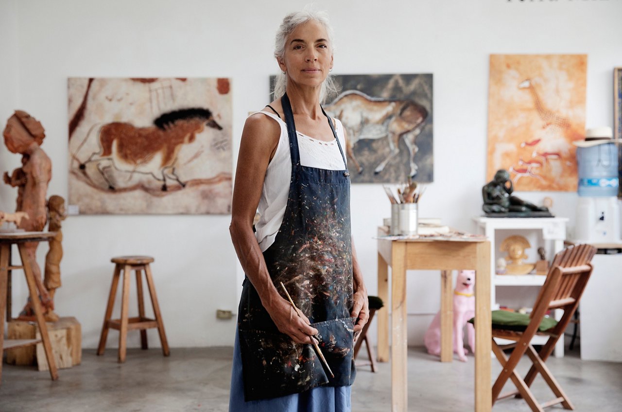 A lady with paintings and brushes