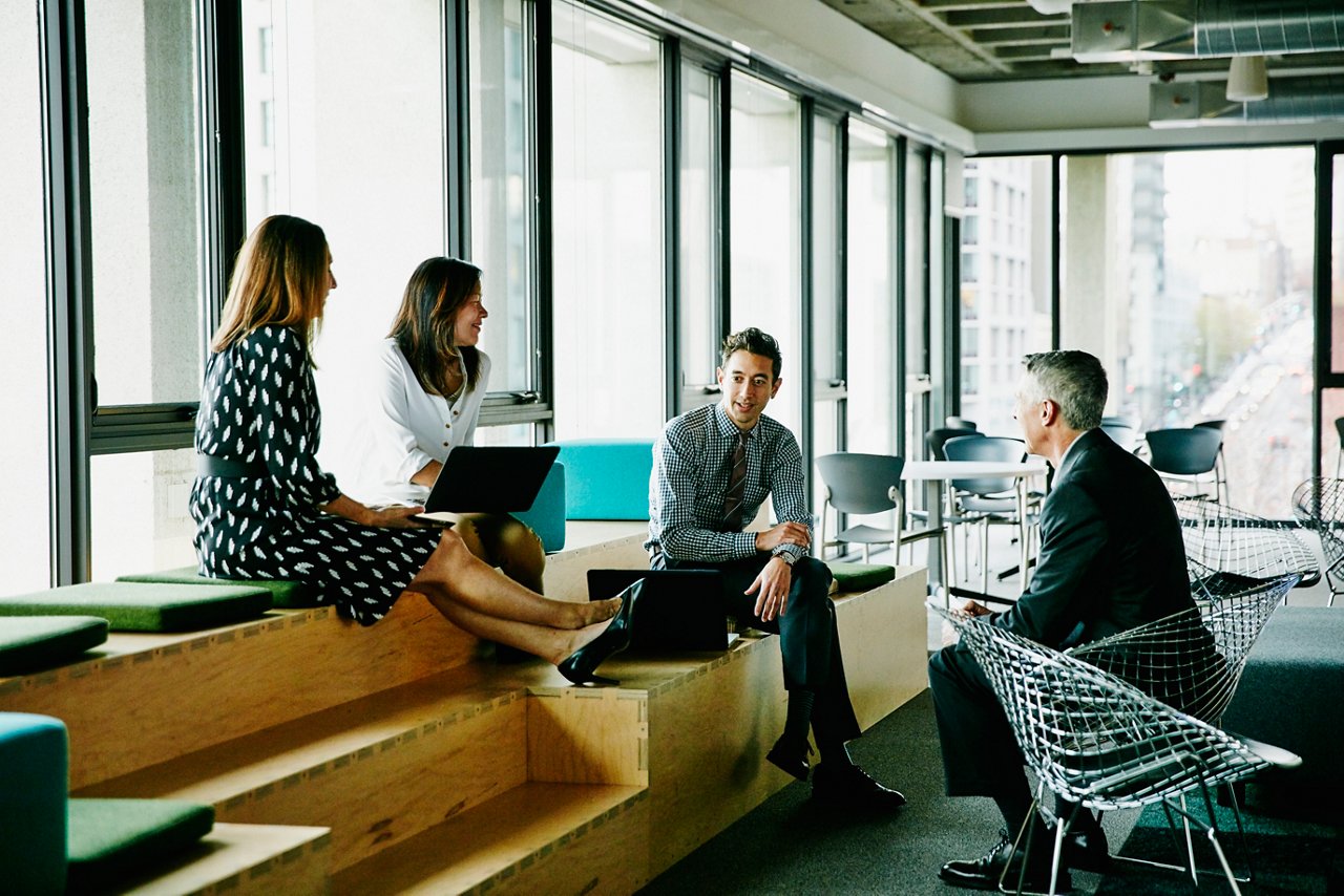 Colleagues meeting and collaborating in an informal office gathering space