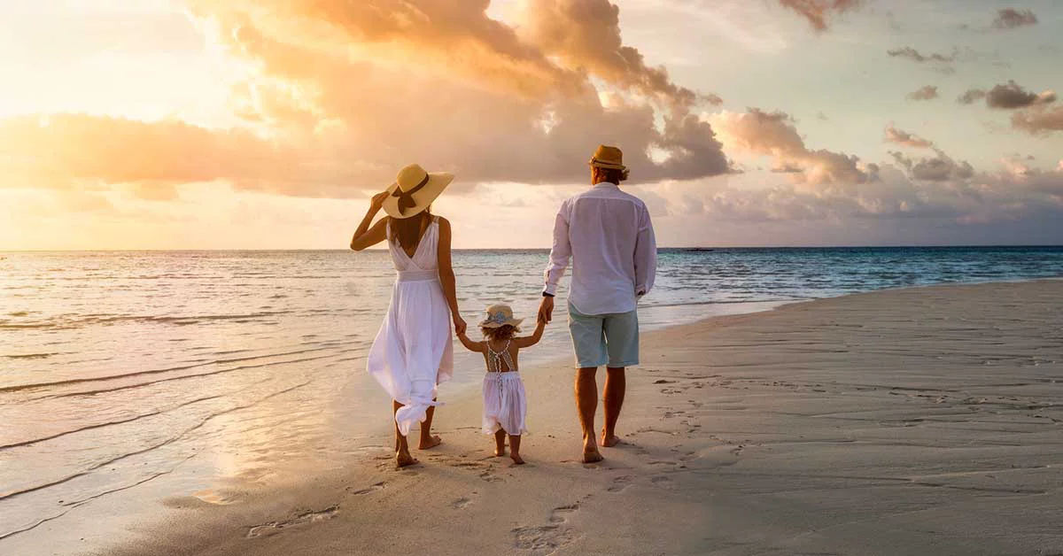 Family enjoying the sunset on beach side