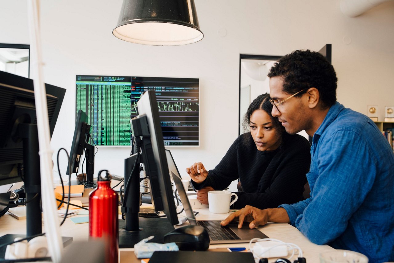 Asian man and woman working in office