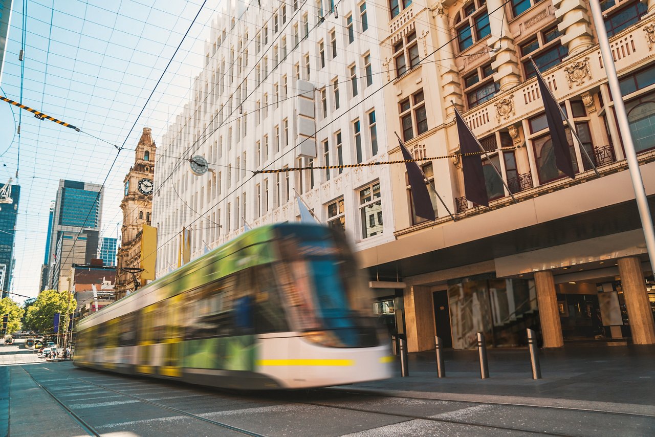 Bourke St Mall with tram passing through frame.
