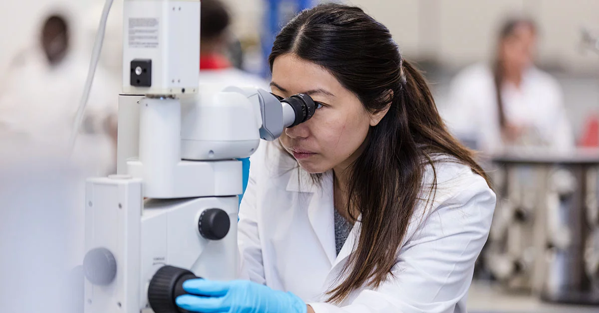 Doctor Looking Into Microscope
