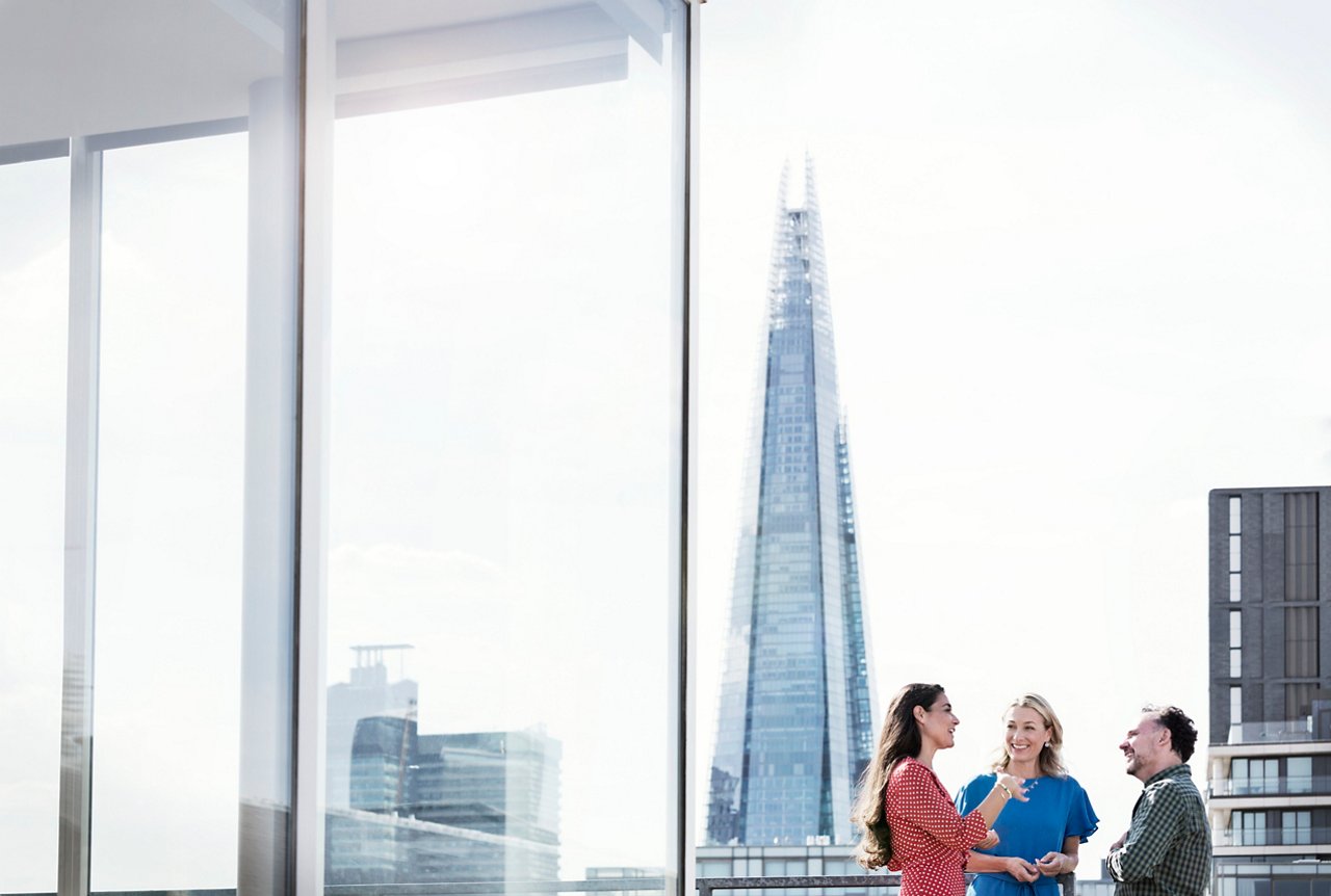 Business people talking on sunny urban rooftop