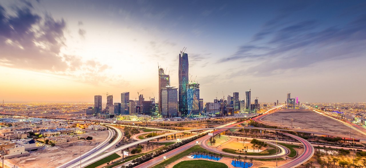 Night view of a city with high rise buildings and highways