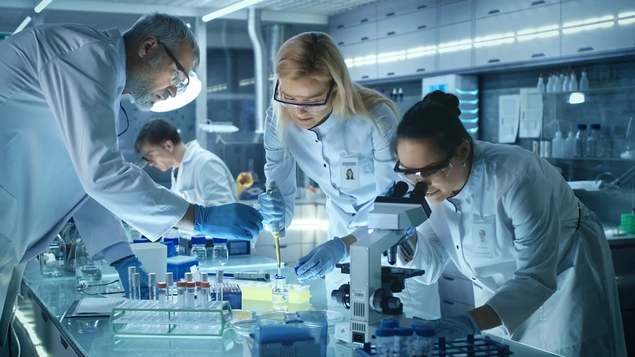 A team of scientists working in a life sciences research laboratory.