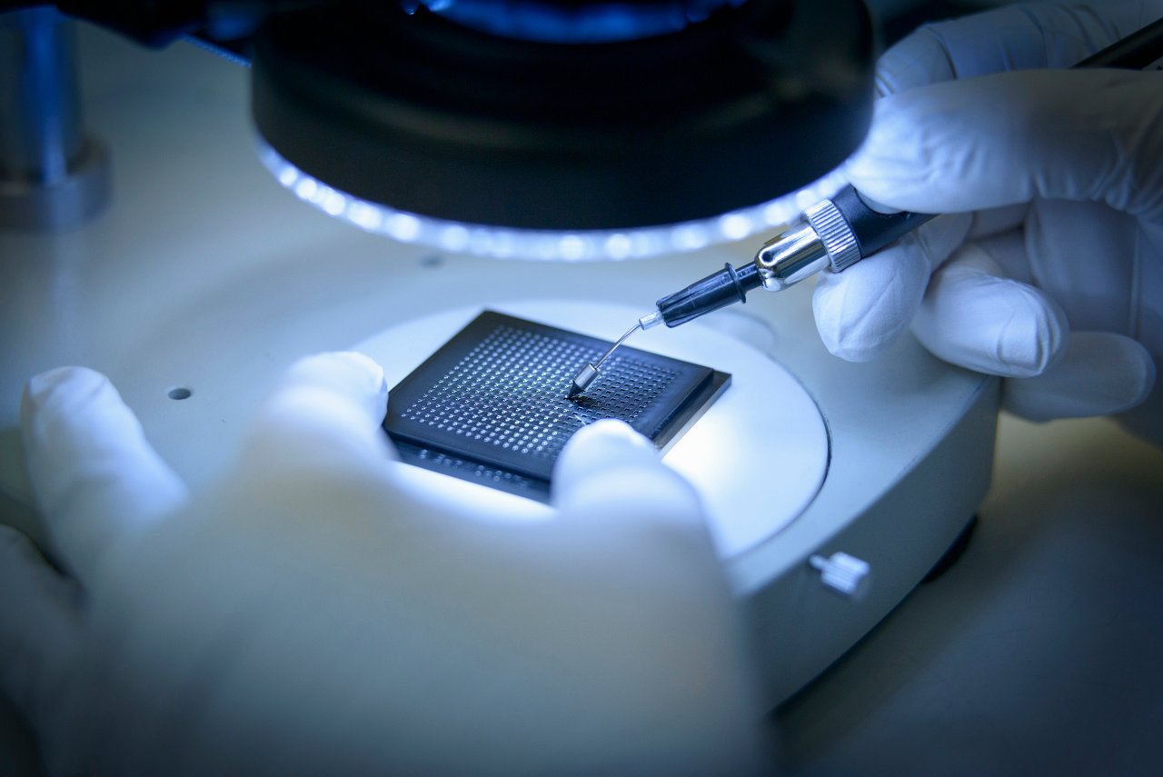 A man working on a processor while wearing gloves