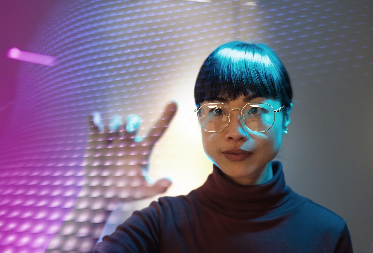 Asian scientist using technologies in modern office