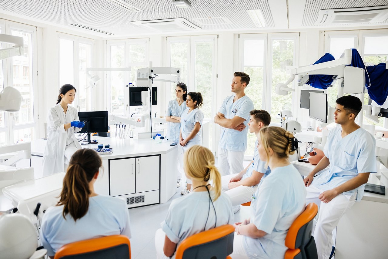 Students Listening To Teacher Talking In Dental Surgery