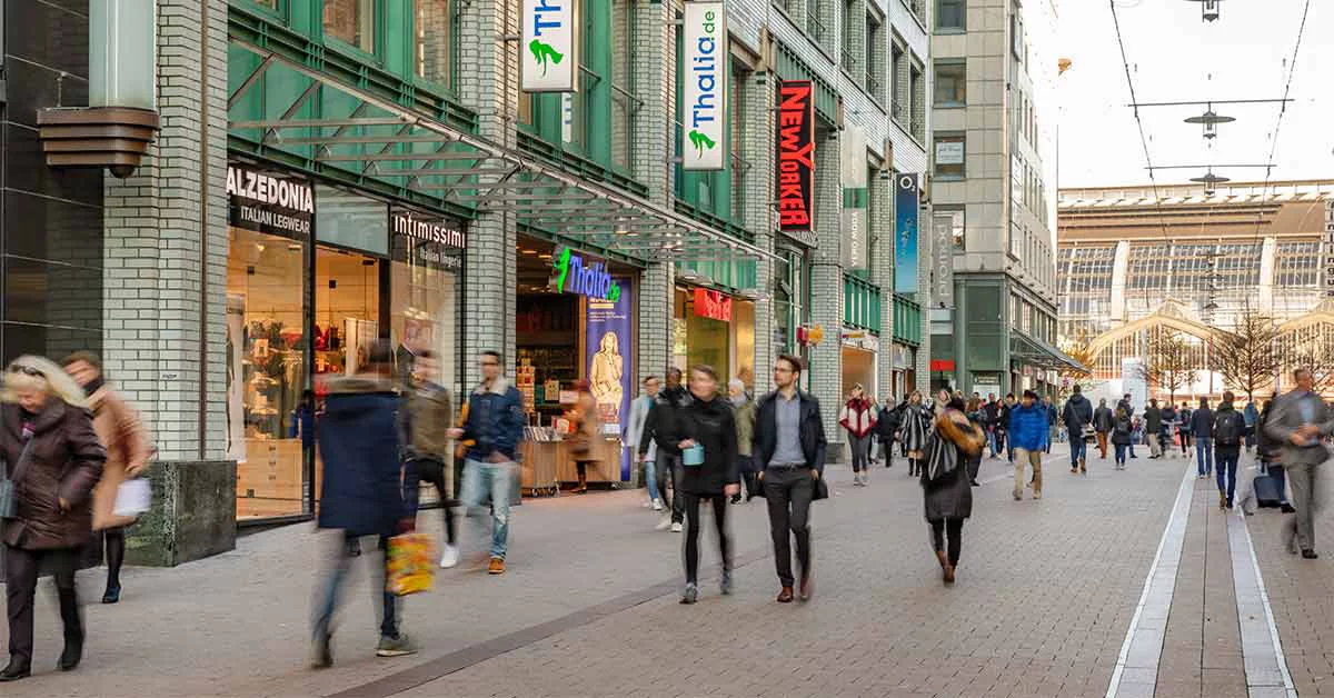 People are walking infront of the Shopping mall