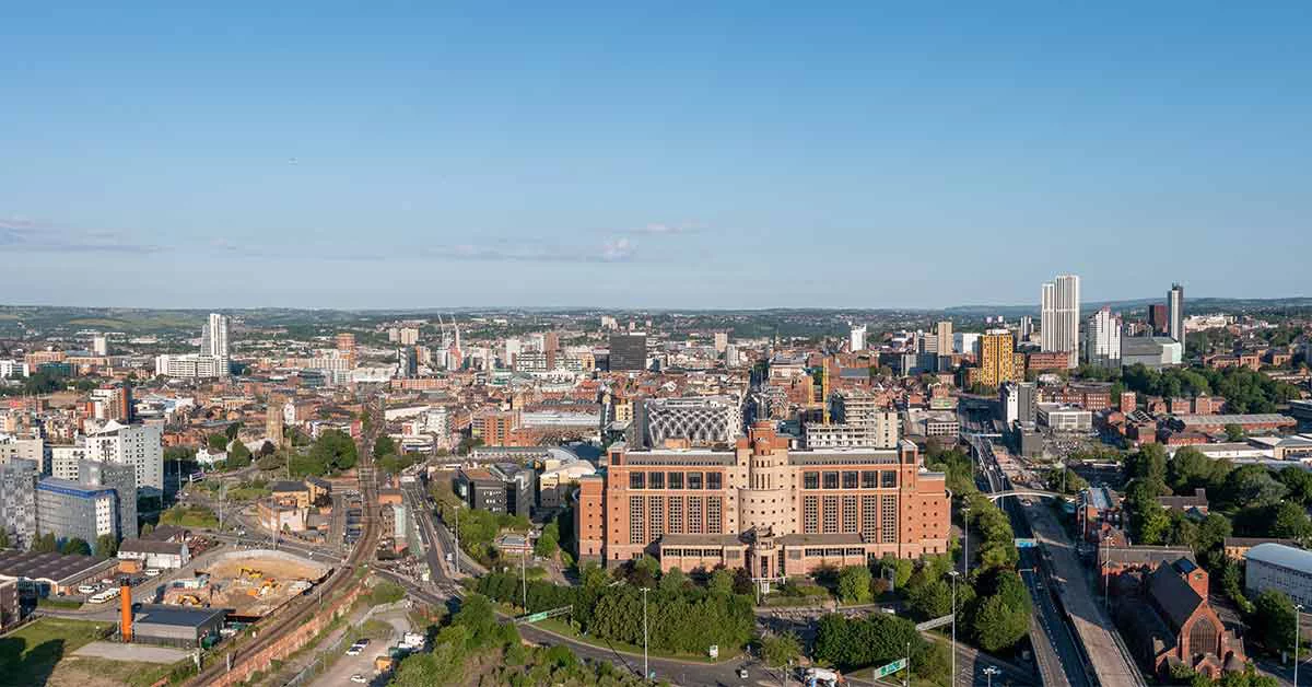Leeds city centre on a sunny day showing large council office buildings and surrounding retail stores