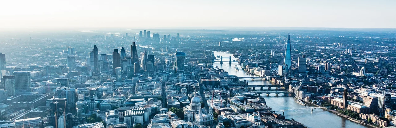 London aerial at dawn showing City of London, The Shard and Canary Wharf.