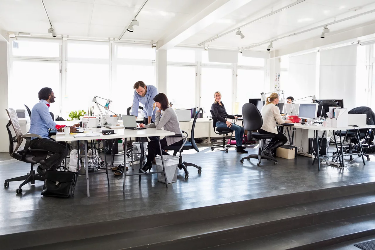People in the office discussing and working with each other