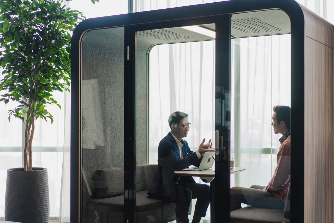 Employees talking in meeting inside JLL office chamber