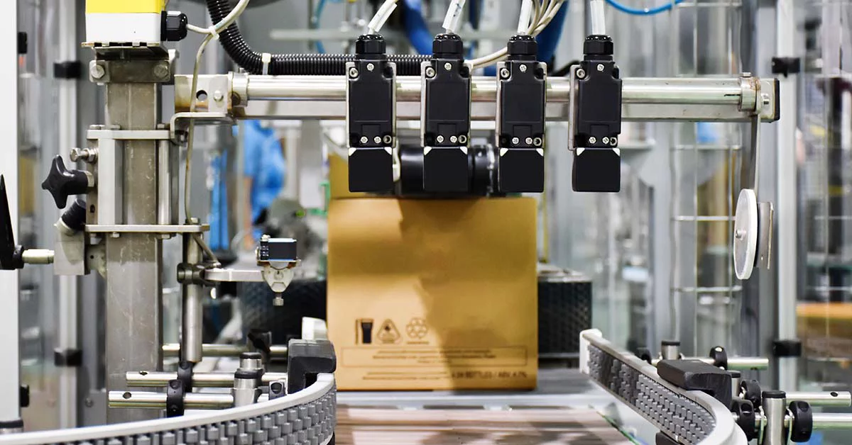 A machine is actively moving a package on a conveyor belt within a logistics facility.