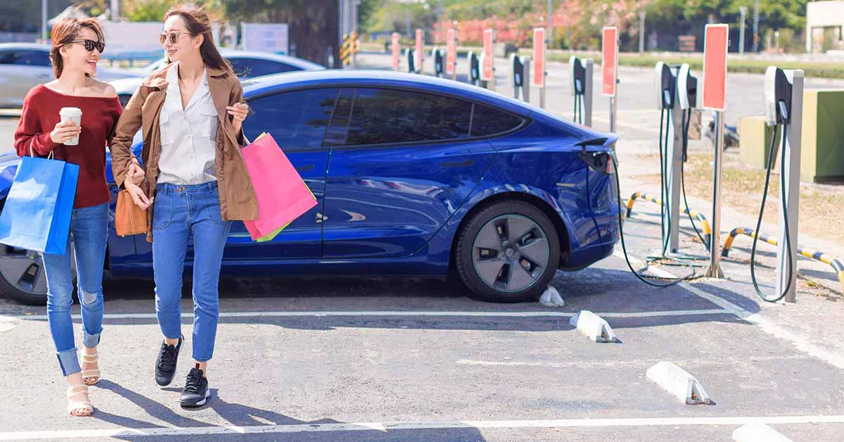 two women in Tesla charging station